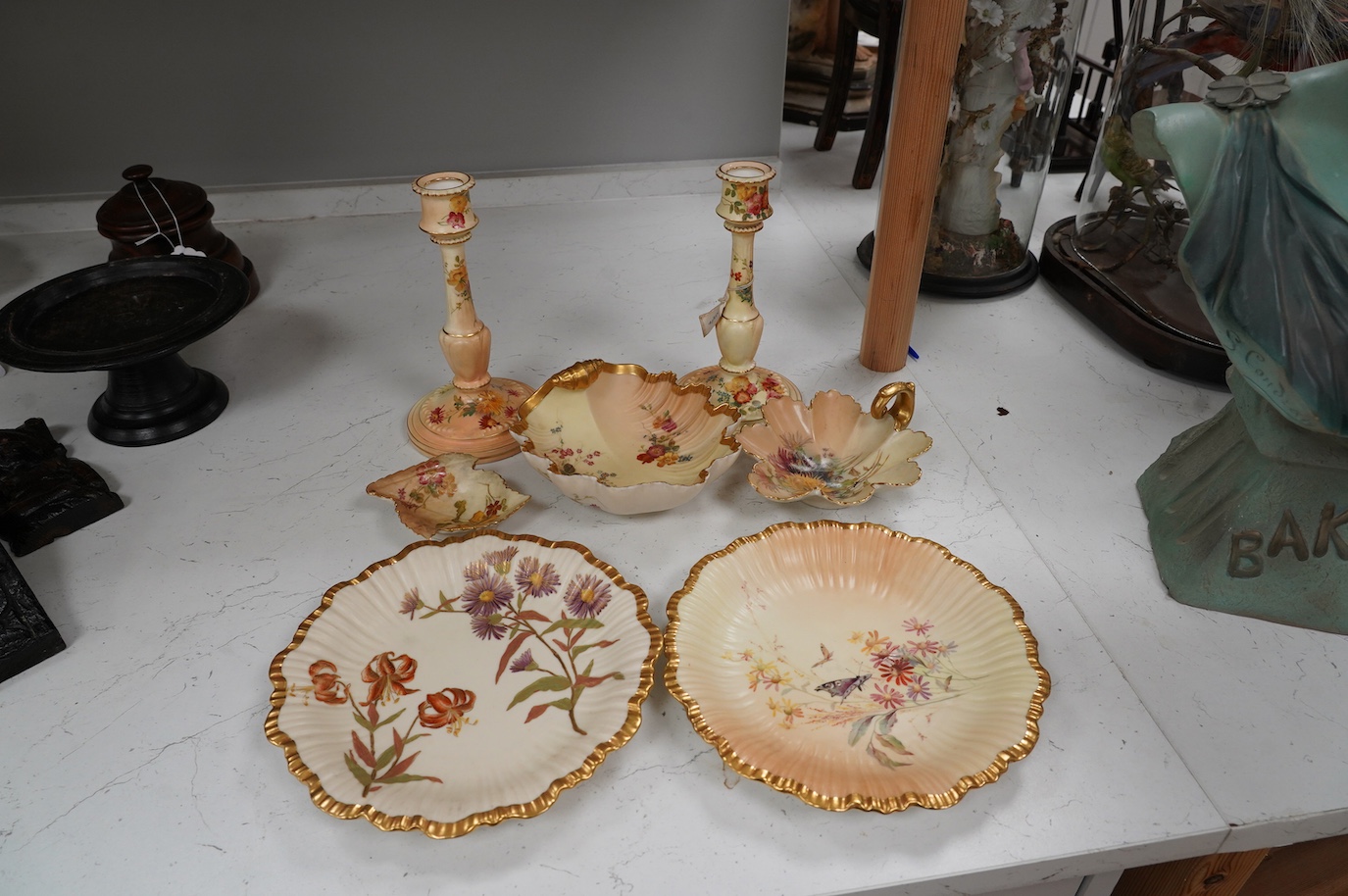 A pair of Royal Worcester blush ivory candlesticks, three bon bon dishes and a pair of plates, tallest 20cm. Condition - mostly good, some damage